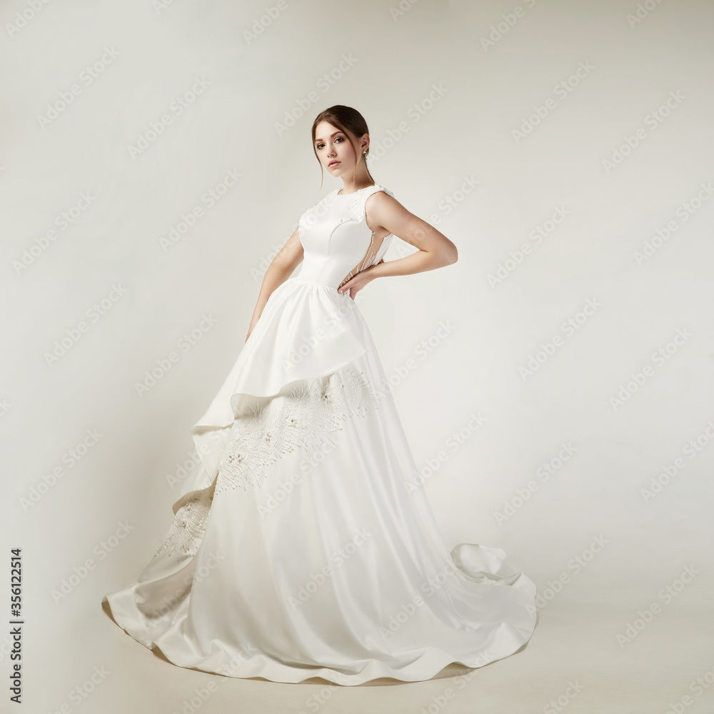 girl in a white satin dress with lace on a white background girl in a white satin dress with lace on a white background