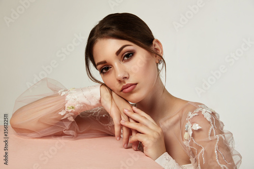 girl in a pink dress with tulle with lace on a white background