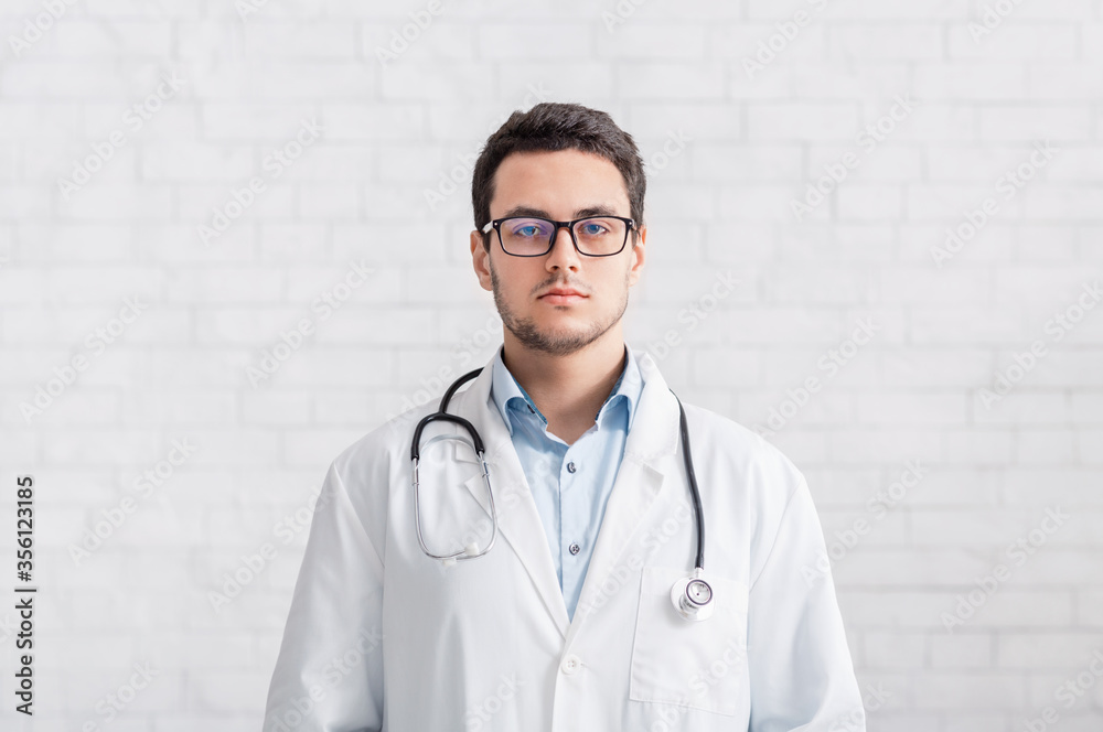 Online conference and doctor presentation. Man with stethoscope on a white wall background Online conference and doctor presentation. Man with stethoscope on a white wall background