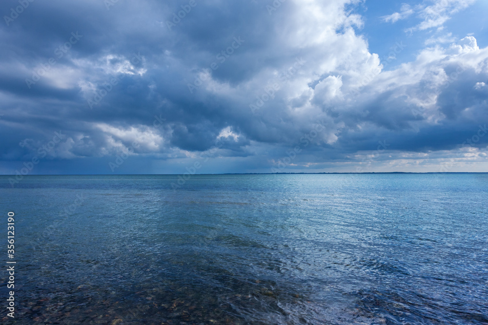 Blue water at bay on cloudy summer day. Blue water at bay on cloudy summer day.