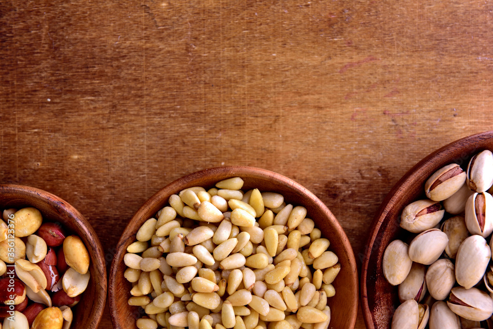 Mix of nuts in a wooden bowl Mix of nuts in a wooden bowl