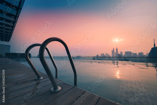 Canvas Print Cityscape of Kuala lumpur city skyline with swimming pool on the roof top of hotel at sunrise in Malaysia