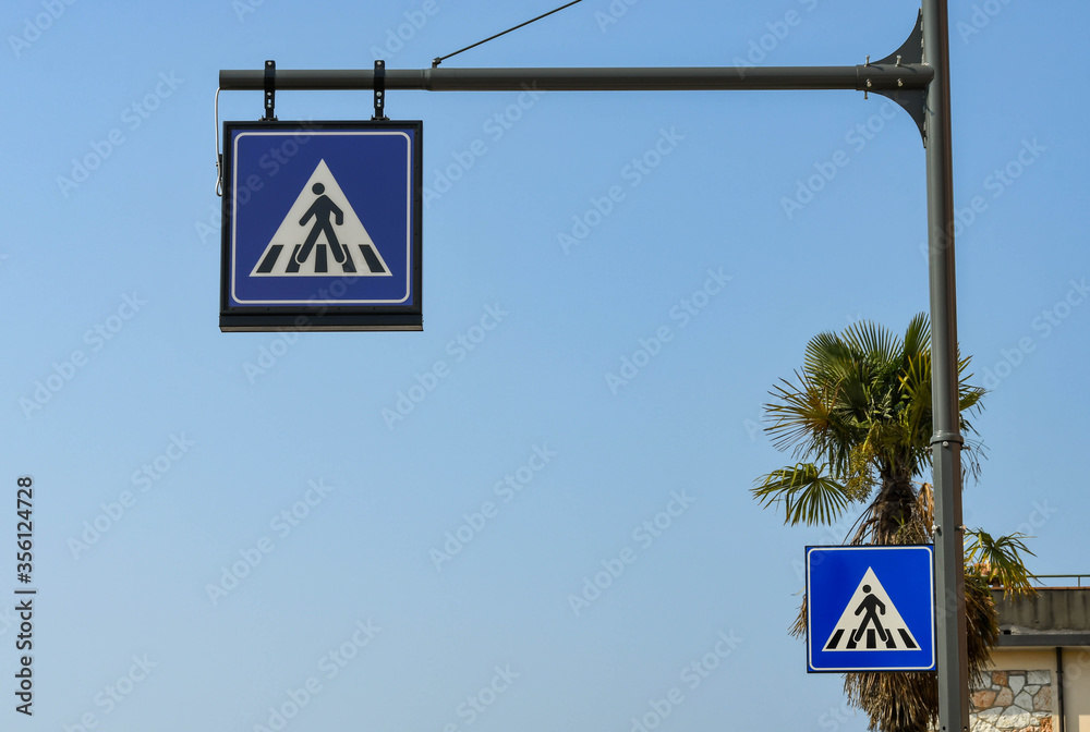 Road signs in Italy warning drivers of a pedestrian crossing. No people. Road signs in Italy warning drivers of a pedestrian crossing. No people.