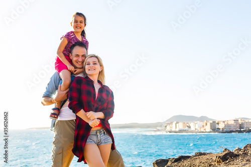 happy young family have fun on beach run and jump at sunset © Angelov
