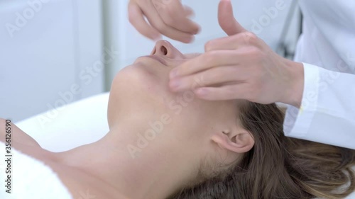 Close-up 4K video of woman enjoying japanese face massage in professional salon