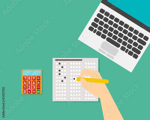 Top view: Exam or education test concept. There are laptop, answer sheet, calculator, pencil in right hand on the desk. 