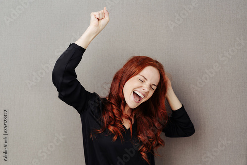 Fotografija Motivated young woman cheering and celebrating