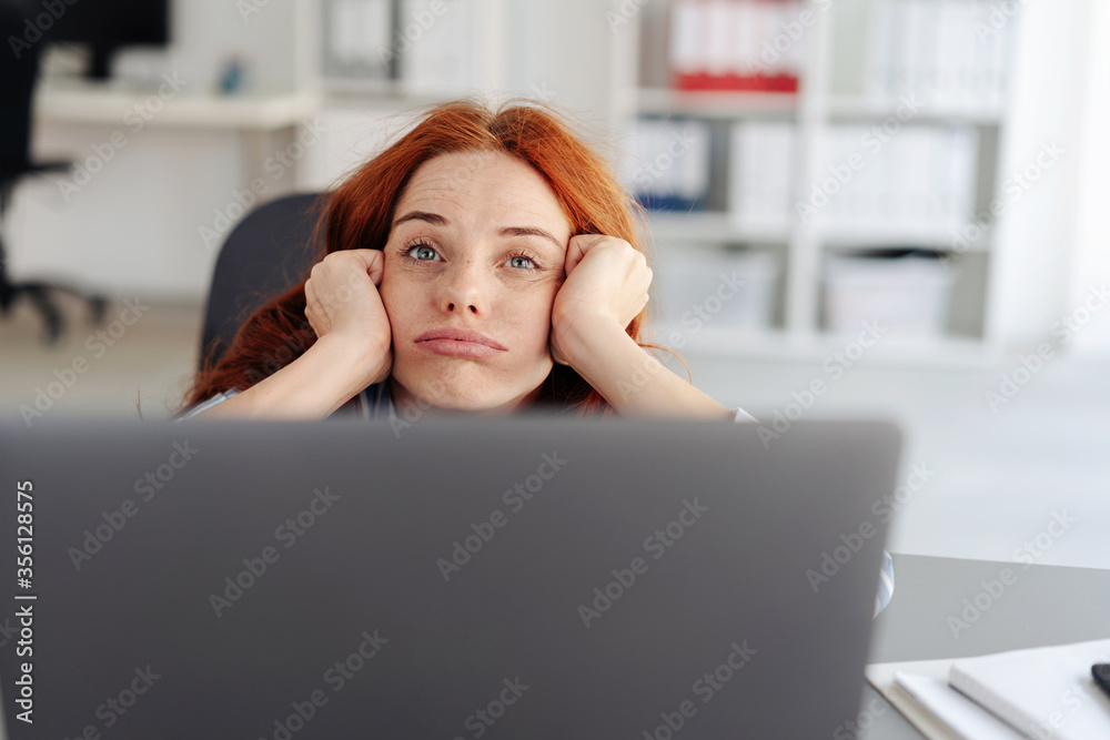 Bored young businesswoman pulling a face Bored young businesswoman pulling a face