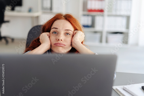 Bored young businesswoman pulling a face