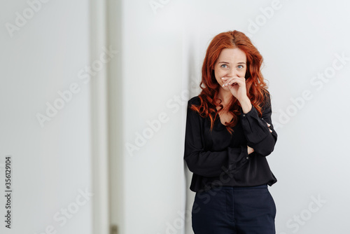 Embarrassed young woman chuckling to herself