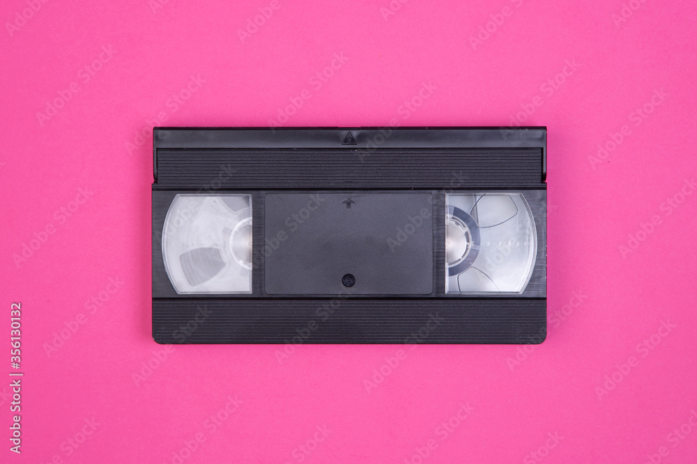 Obraz premium VHS tape from the 80s and 90s on pink background and space to write on it