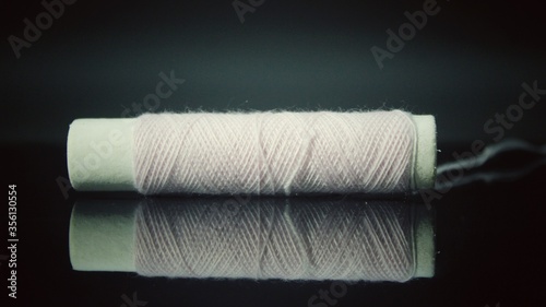 White spools of thread isolated on black background 