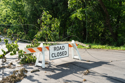 Road Closed sign with tree and power lines down after a big storm