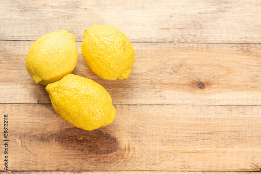 Ripe tasty lemons on a wooden table. Healthy food