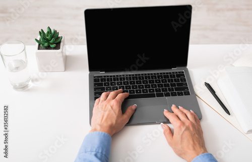 Work with documents and charts. Mature woman hands work an laptop
