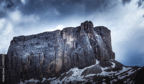Dark mood photo of a dolomite mountain against dramatic sky