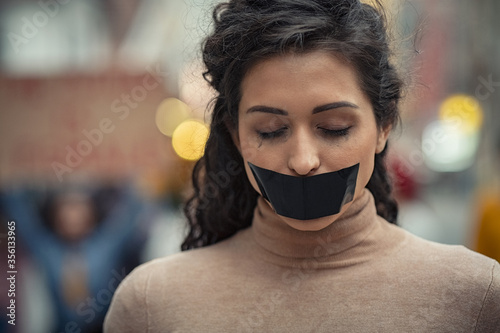 Woman fighting against harassment with closed eyes photo