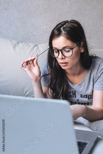 Young woman studying with video online lesson at home
