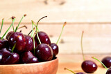 Red cherry in a wooden bowl