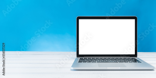 laptop mockup, home and office workspace concept. Laptop computer white blank screen on work table front view. Copy space