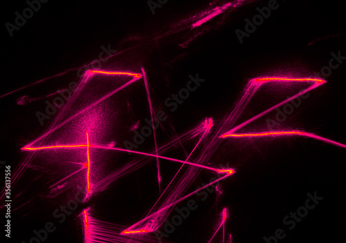 Abstract pink lines drawn by light on a black background