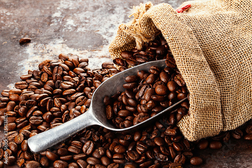 bag with fresh roasted coffee lying on old rustic textured background