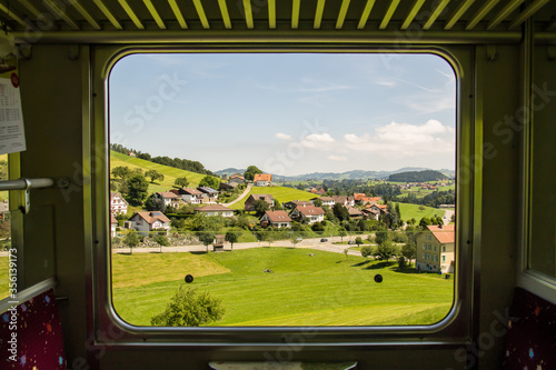View through train window in Switzerland with landscape near Appenzell.