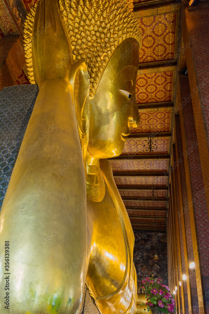 Reclining big Buddha gold statue in Wat Pho, Bangkok, Thailand