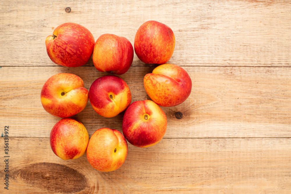 Large ripe and juicy nectarines on a wooden table. Healthy diet Large ripe and juicy nectarines on a wooden table. Healthy diet