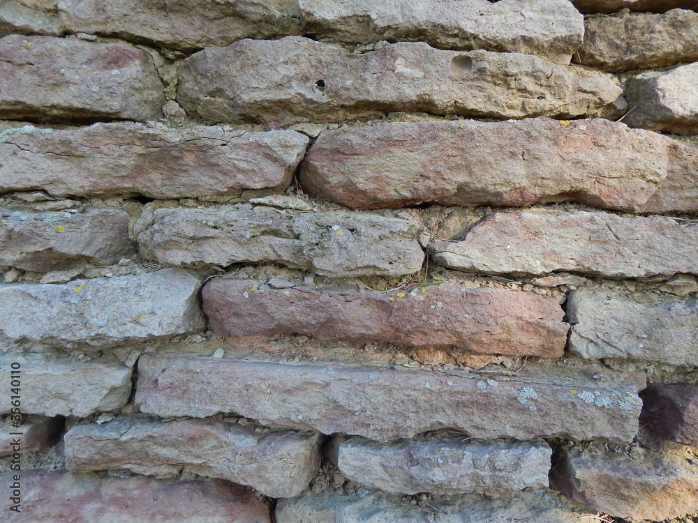 Wall of flat natural stones without facing, interesting texture Wall of flat natural stones without facing, interesting texture