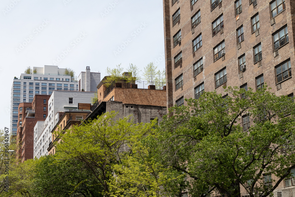 Row of Old Buildings and Skyscrapers on the Upper East Side of New York City Row of Old Buildings and Skyscrapers on the Upper East Side of New York City