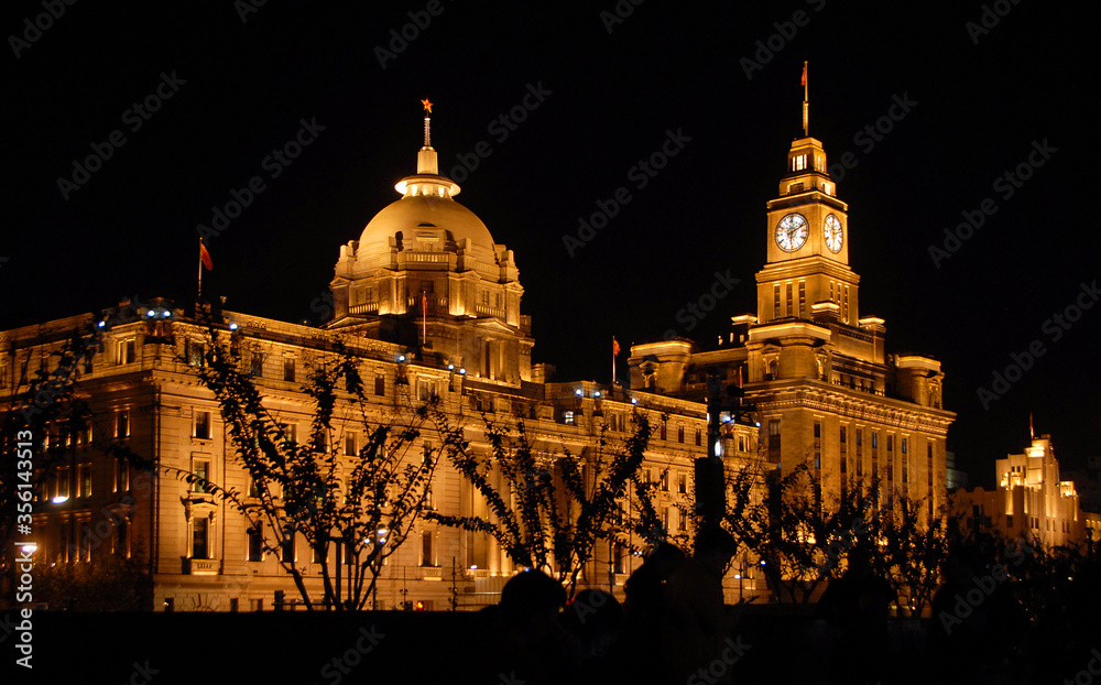 The Bund in Shanghai, China. The Bund is a riverfront area in central Shanghai with many historic concession era buildings. The illuminations on the Bund at night are popular with tourists in Shanghai