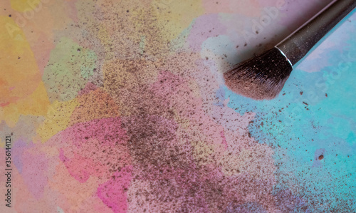 Make up brush with powder on colorful background. Copy space