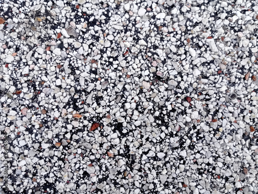 Sea pebbles texture. Multicolored small boulder and stone texture. Gravel pebble background. Small stones on the ground. Natural colorful gravel on summer beach. Sea pebbles texture. Multicolored small boulder and stone texture. Gravel pebble background. Small stones on the ground. Natural colorful gravel on summer beach.
