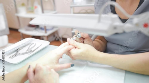 the manicure master cuts off the gel Polish on the client's hands. High quality FullHD footage