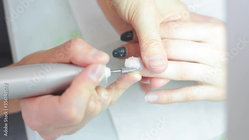 the manicure master cuts off the gel Polish on the client's hands. High quality FullHD footage