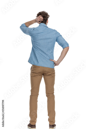 Εκτύπωση καμβά back view of casual man scratching head and thinking