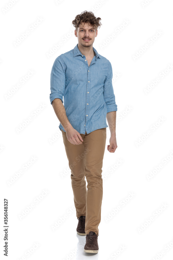 Fototapeta premium happy casual man in denim shirt smiling and walking