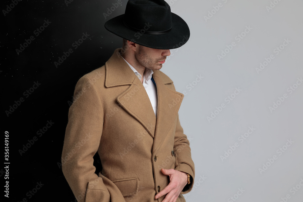 sexy young fashion model looking to side and adjusting longcoat sexy young fashion model looking to side and adjusting longcoat