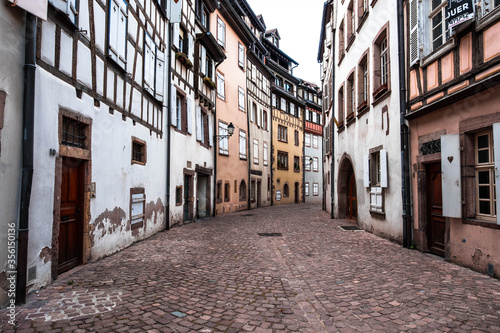 A narrow street with traditional architecture in the center of Colmar in Alsace, France