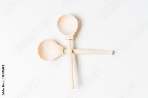 two wooden spoons and three sections of wood, blank for your design, top view on a white background