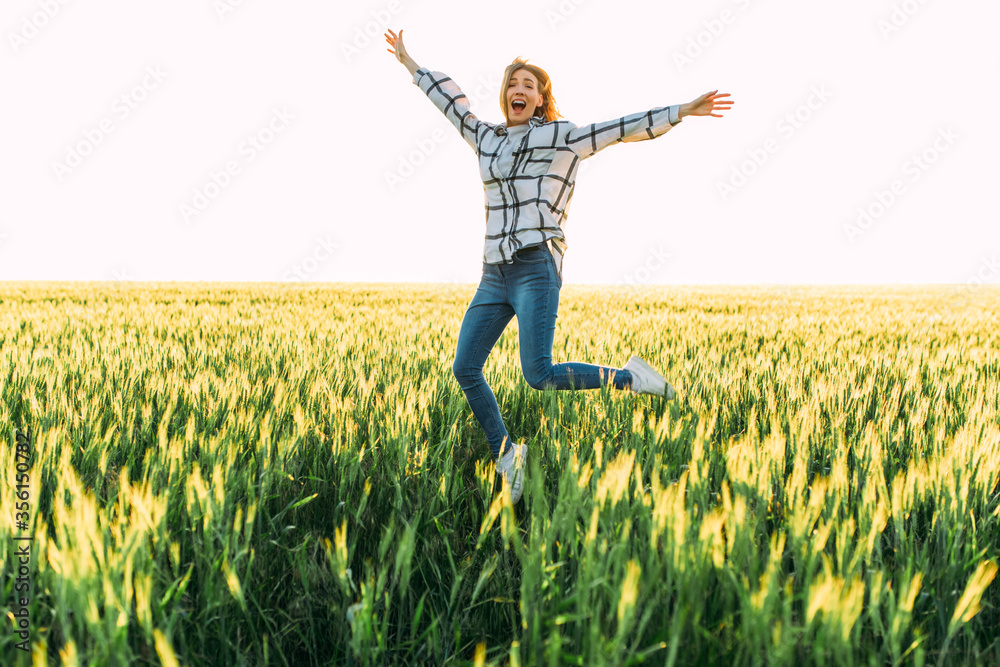Happy woman jumps in Golden wheat Happy woman jumps in Golden wheat