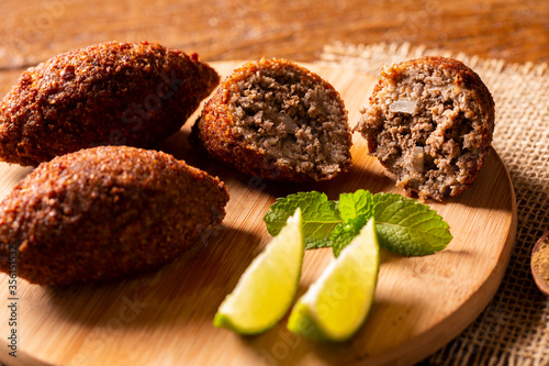 Kibbeh - Middle Eastern minced meat and bulghur wheat fried snack. Also popular party dish in Brazil (kibe). photo