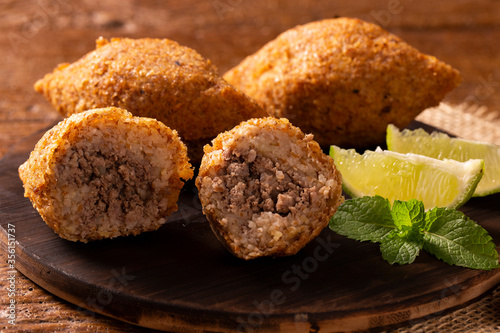 Potato Kibbeh - Middle Eastern minced meat and bulghur wheat fried snack made with potato. Also popular party dish in Brazil (kibe). photo