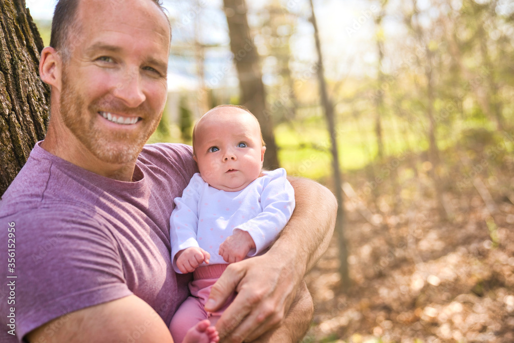 Beautiful father And Baby outdoors. Dad and her Child playing together Beautiful father And Baby outdoors. Dad and her Child playing together