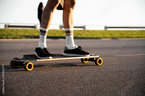 Young man's legs on a skateboard photo