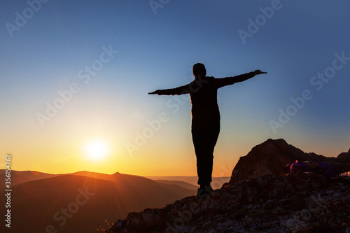 silhouette of a girl at sunset in the mountains