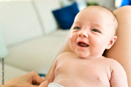 mother with her newborn baby on knee