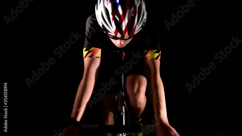 professional triathlete cycling road bike, Pedaling, sport concept, studio black photo