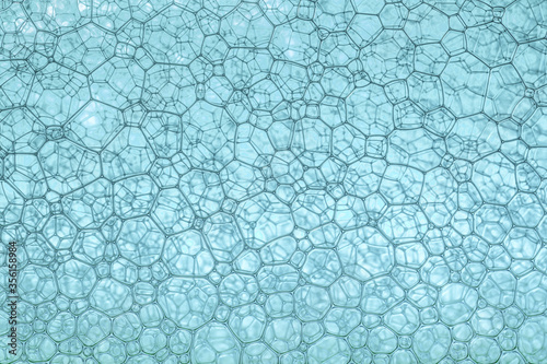 Abstract background and texture of blue bubbles with light illumination. The art of water surface for your products display and artwork design with copy space. Watery glare like jewelry so beautiful.